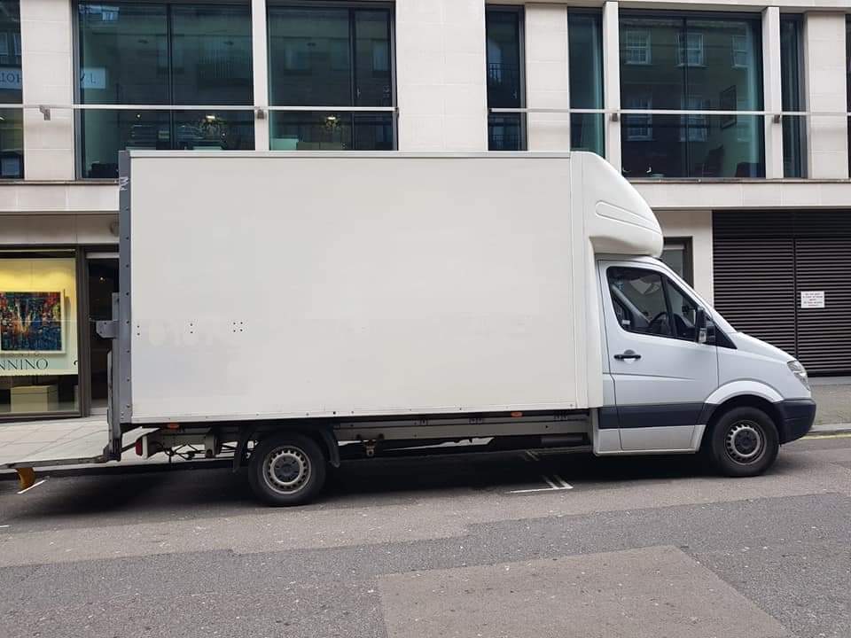 A Local Express Removals white Luton box van parked kerbside outside offices on a central London street